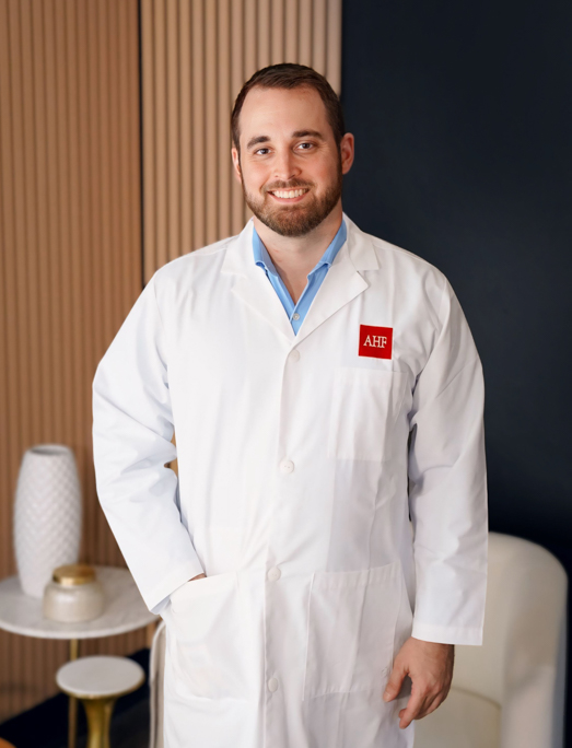 Dr. Jacob Lyon's white coat headshot